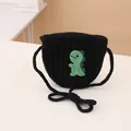 Kids knitted drawstring crossbody bag in black featuring a green dinosaur patch detail - Knitted Crossbody Bag / Black