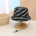 Close-up of black cotton fisherman hat with white letter print and windproof cord - Kids (Approx. 2-8 Years) / Black