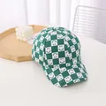 Close-up of green and white checkerboard baseball cap with smile pattern on canvas material - Kids / Green