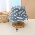 Detail of grey-blue cotton bucket hat featuring white letter prints and adjustable wind cord - Kids (Approx. 2-8 Years) / Blue