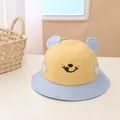 Close-up of baby sun hat with cute smile embroidery and 3D ears on cotton fabric - Kids (About 2-6 Years Old) / Yellow
