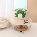 Detail of cartoon frog print and adjustable chin strap on beige cotton bucket hat - Kids / Beige