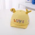 Detail of yellow baby baseball cap with plush fish fins and colorful LOVE embroidery - Yellow