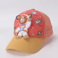 Detail of kids baseball cap featuring 3D cartoon astronaut bear and space theme prints - Kids / Orange
