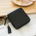 Minimalist black square zipper wallet with pebble leather texture and tassel detail - Black