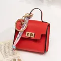 Mini red leather handbag keychain with silk scarf detail and golden ring clasp - Red