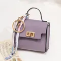Mini lavender leather handbag charm with gold hardware and decorative floral scarf - Purple