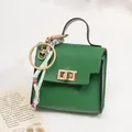 Mini green pebbled leather bag with gold hardware and silk scarf keychain detail - Green