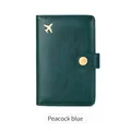 Peacock blue RFID passport holder with golden airplane emblem and snap closure - Teal