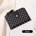 Slim black women's wallet with blue floral print and golden button closure - Black