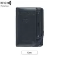 Dark grey RFID blocking passport holder with elastic strap and engraved logo detail - Gray