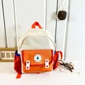 Kids backpack in cream and orange colorblock design with embroidered Good Luck patch - Orange Small