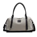 Minimalist canvas travel tote bag with black leather trim and adjustable strap - Black