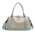Beige canvas travel tote bag with light green accents and adjustable shoulder strap - Green