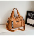 Detail of camel travel bag showing cat ear logo embroidery and adjustable shoulder strap - No Pendant / Brown