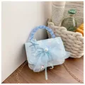 Detail of light blue lace kids bag with mesh bow, pearl center, and beaded handle - Blue