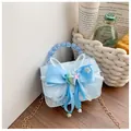 Light blue lace girl's handbag with large bow and starfish accents in soft outdoor setting - Blue Star