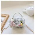 Detail of tweed children's handbag with pearl handle, rabbit doll, and gold chain strap - White Rabbit Black