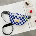 Kids chest bag featuring a blue and white checkerboard pattern with neon green zippers - Blue