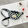 Classic checkerboard kids chest bag with adjustable logo strap and neon zipper detail - Black