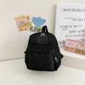 Mini sac à dos noir pour maternelle en nylon avec logo et poche avant zippée - Noir