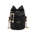 Black quilted bucket bag with large bow and golden chain strap for girls - Black