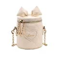 Beige quilted bucket bag for kids featuring a large bow and golden Love heart charm - White
