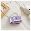 Detailed macro view of purple tweed fabric with lace trim and elegant pearl handle - Plaid Bow / Purple