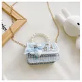 Close-up of children's tweed crossbody bag featuring pearl handle and gold chain details - Plaid Bow / Blue