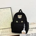 Black nylon kids backpack with cartoon bear patch and decorative bear paw print details - Black