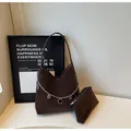 Macro shot of dark brown suede hobo bag with silver chain charms and small pouch - Tote Bag And Pouch Set / Brown