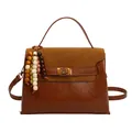 Retro brown contrast handbag with textured leather and wooden bead tassel in soft lighting - Yellow Brown (With Charm)