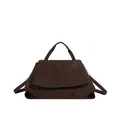 Detailed view of dark brown matte leather tote bag featuring a geometric trapezoid structure - Brown