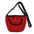Red knit crossbody bucket bag with black woven strap and smile pattern design - Red