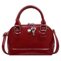Deep red patent leather shell handbag with heart charm and adjustable shoulder strap - Red