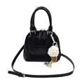 Black shell-shaped leather handbag with double handles and knitted ice cream charm - Black