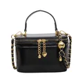 Black square box shoulder bag with gold chain strap and heart charm in a front view - Black