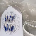 Handmade coffin nails with blue and white abstract wave patterns and silver glitter - Extra Small (XS)