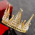 Detailed side view of golden bridal crown with pearls and rhinestones on a display stand - Rabbit Ears With Rhinestones / Gold