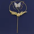 Elegant gold metal round cake topper with white mesh butterfly and pearl flower details - Gold