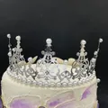 Silver crown cake topper with elegant white pearls and rhinestones on a black background - Few Rhinestone Style / Silver
