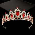 Close-up of golden bridal crown with red teardrop gemstones and sparkling rhinestones - Gold with Red Rhinestones