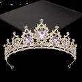 Detailed close-up of a gold-plated crown with purple teardrop gems and white rhinestones - Gold with Purple Rhinestone