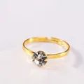 Close-up of adjustable gold-plated ring featuring a sparkling four-prong round zircon - White Zirconia Women's Ring / Gold