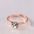 Macro shot of rose gold plated adjustable solitaire ring with round brilliant cut crystal - White Zirconia Women's Ring / Rose Gold