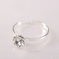 Macro shot of a minimalist silver plated bridal ring with a round claw-set diamond solitaire - White Zirconia Women's Ring / Silver