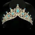 Elegant gold bridal crown with blue sapphire crystals and white rhinestones on black stand - Lake Blue