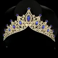 Detail of luxury gold crown with deep blue marquise stones and sparkling crystals - Sapphire Blue