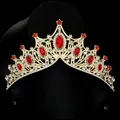 Macro detail of golden baroque bridal crown with red gems and sparkling crystals - Red
