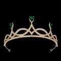 Detailed close-up of golden bridal tiara with green teardrop gems and white crystals - Gold + Green